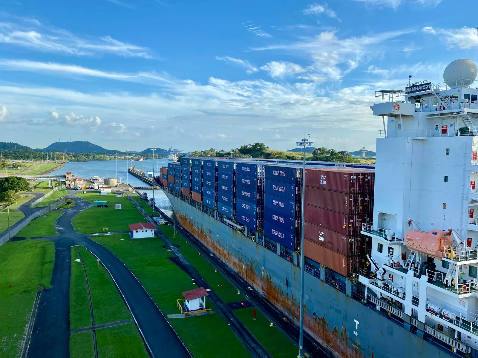 Shipping containers piled high on a ship docked at port