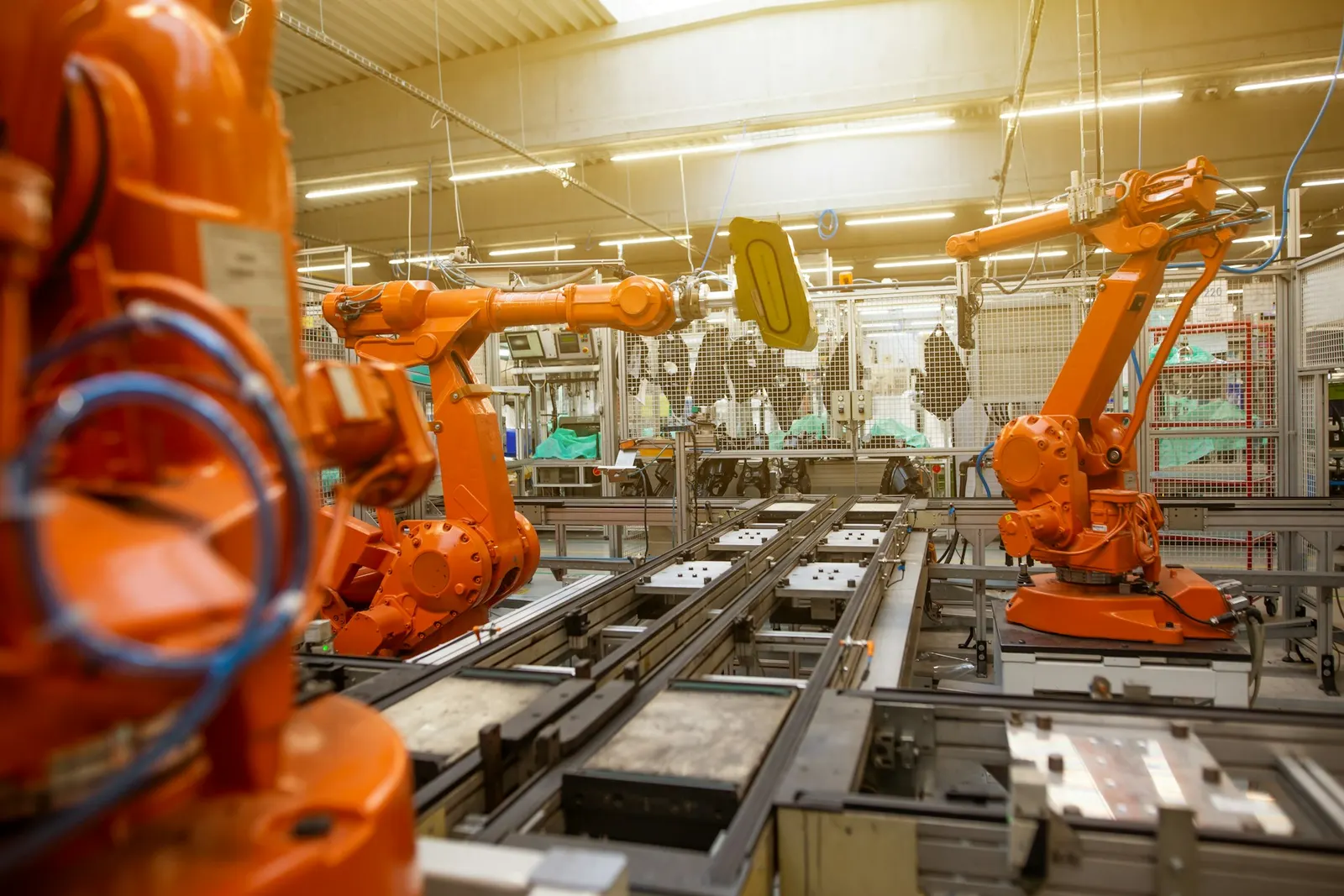 Factory line with robotic arms and machines to assemble items