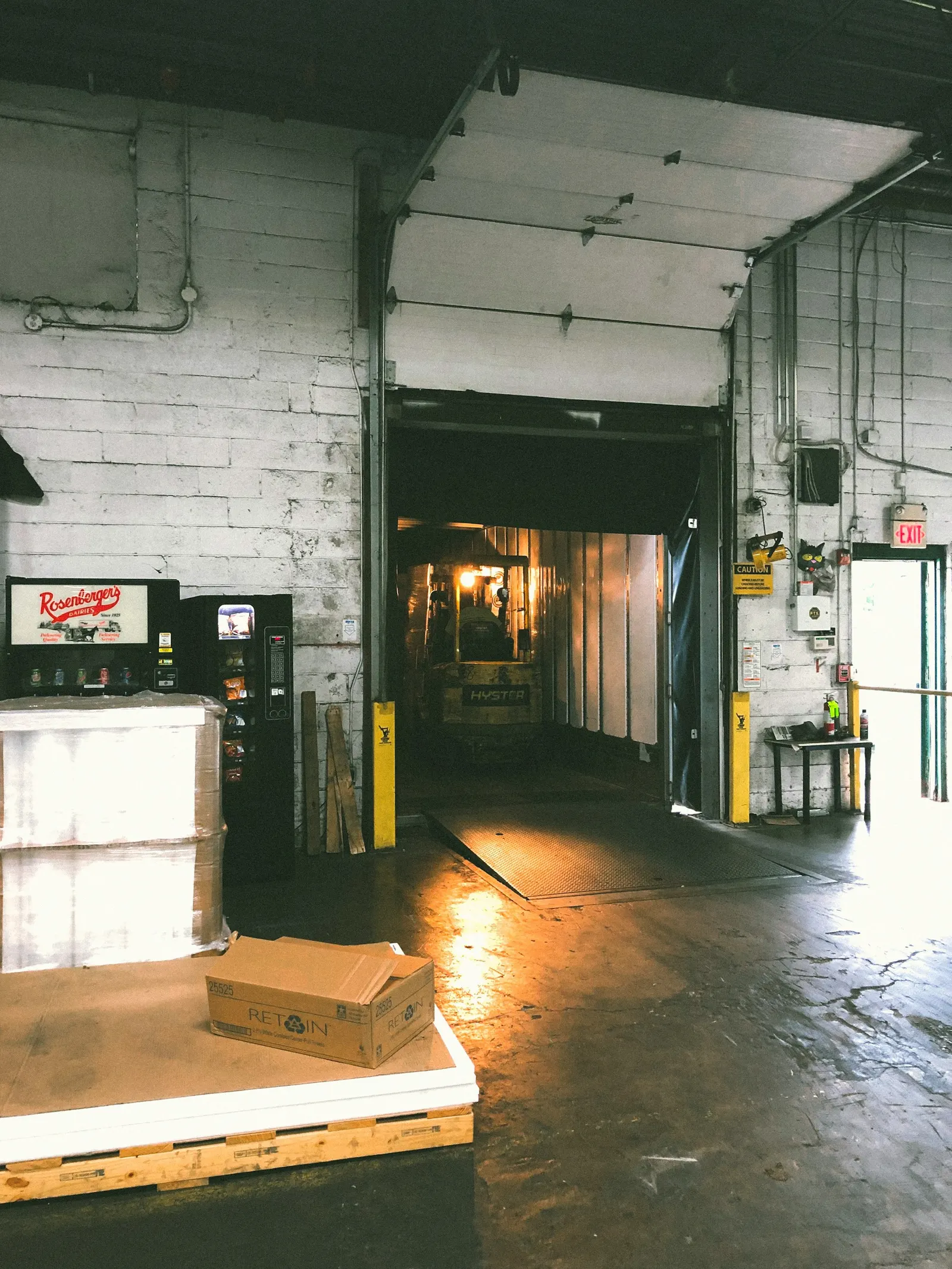 A refrigerated warehouse interior with shipping boxes and insulated packaging being staged for delivery. Clean, modern, high-tech atmosphere.